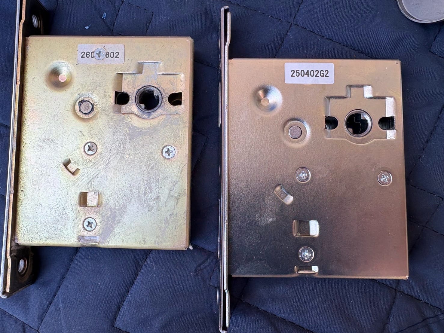 新品のケースロックと扉から取り外したケースロックが並べてられている