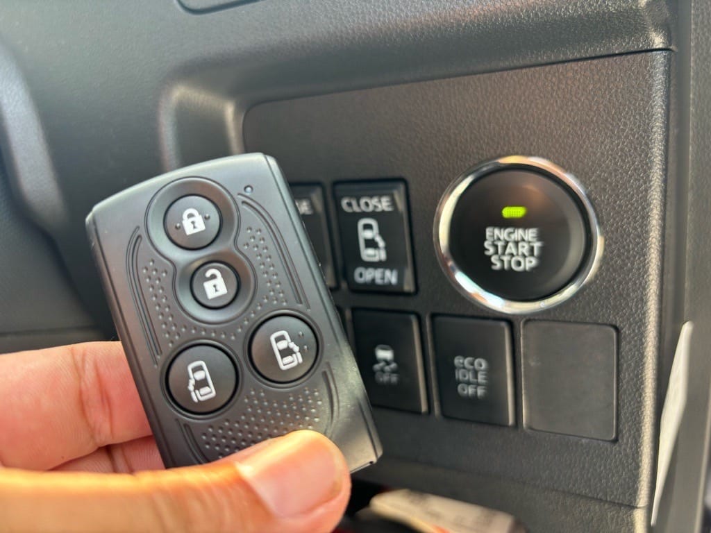 登録が完了したタントのキーフリーリモコンをスタートボタンの前で持っている